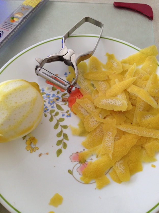 Use a peeler to carefully remove the lemon peels.